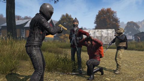 A group of infected closes in on survivors in the street.