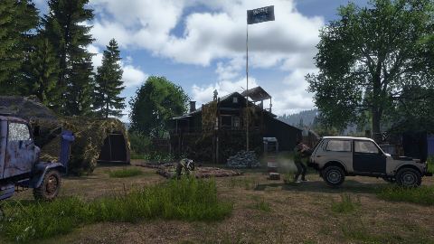 A village road in Chernarus with a car parked by the fence.